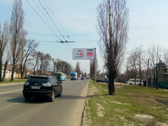 Фото рекламної площини за адресою Героев Сталинграда просп., 70, (магазин "Стройматериалы", автосервис АИС), в направл. просп. 50-летия СССР