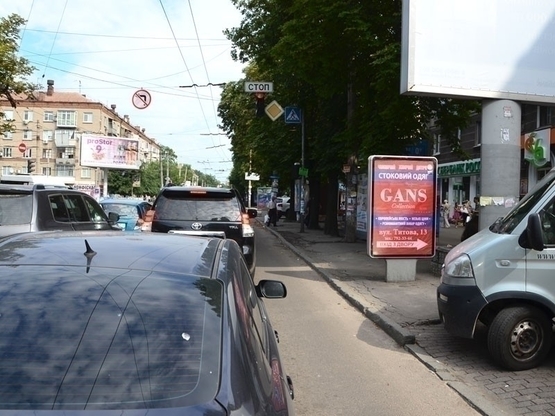 Фото рекламної площини за адресою вул.Титова, 13, перехрестя з пр. О. Поля (супермаркет Сільпо)/ул.Титова, 13 (7) перекресток пр.Кирова - , ЛюксОптика, магазин ЕВА