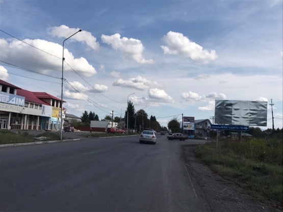 Фото рекламной плоскости по адресу м. Хуст, вул. Івана -Франка, виїзд з міста, в сторону міста Тячів, поворот на с.Шаян, с.Велятино