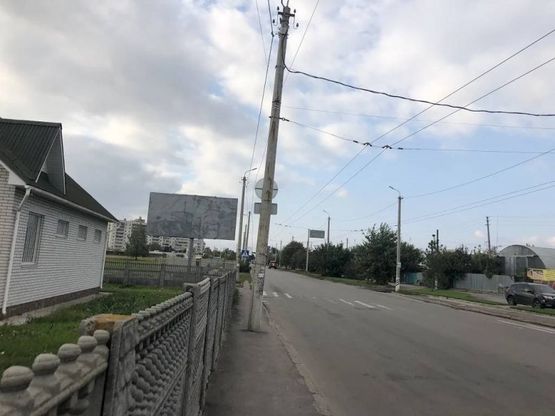 Фото рекламной плоскости по адресу вул. Героїв Чорнобиля перехрестя з вул. Дружби (стадіон БНАУ, напр. до вул. Дружби) сторона Б