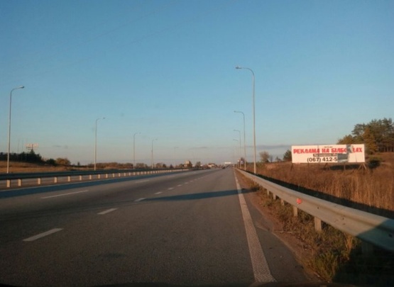 Фото рекламной плоскости по адресу Траса Житомир-Київ.Об'їздна Коростишева. Напроти комплексу"Вояж", напрямок з Житомира на Київ, 3х12 ст.А