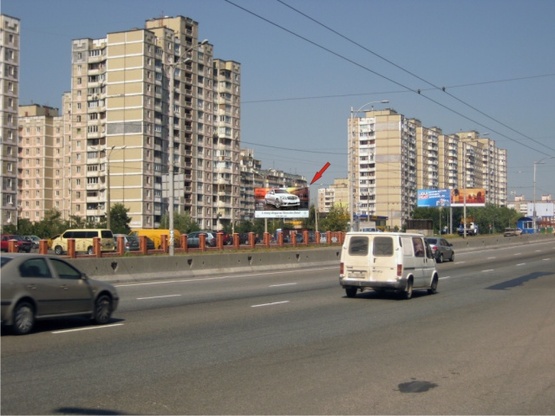Фото рекламной плоскости по адресу Палладина, крупная транспортная развязка, на территории автостоянки, в направлении м. Академгородок ТЦ "Novus"